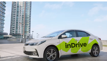 Silver inDrive sedan with green geometric door branding