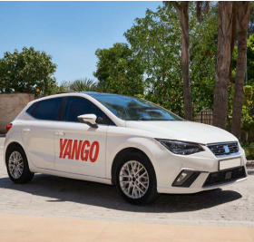 White Yango ride-hailing hatchback with red door branding